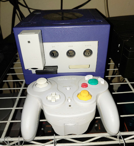 Indigo Gamecube with a gray wirelesss controller