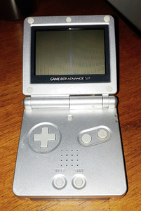 Silver clamshell-hinged squares, with a screen on one and buttons on the other.