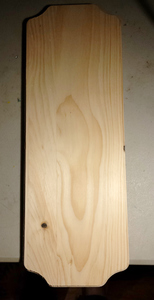 An unfinished wooden board with beveled edges.