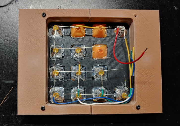 The back of the clock, showing the backs of LEDs inside plastic diffusers, with their leads connected in a grid pattern.