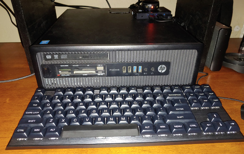 Small desktop pc and keyboard in red and black color scheme