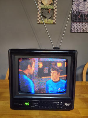 A small CRT Television with antenna extended. It is showing a scene from Star Trek.