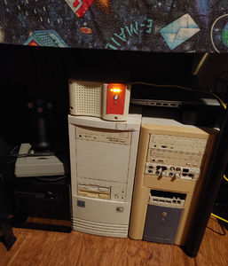 The previosuly pictured biege box next to some biege tower PCs.
